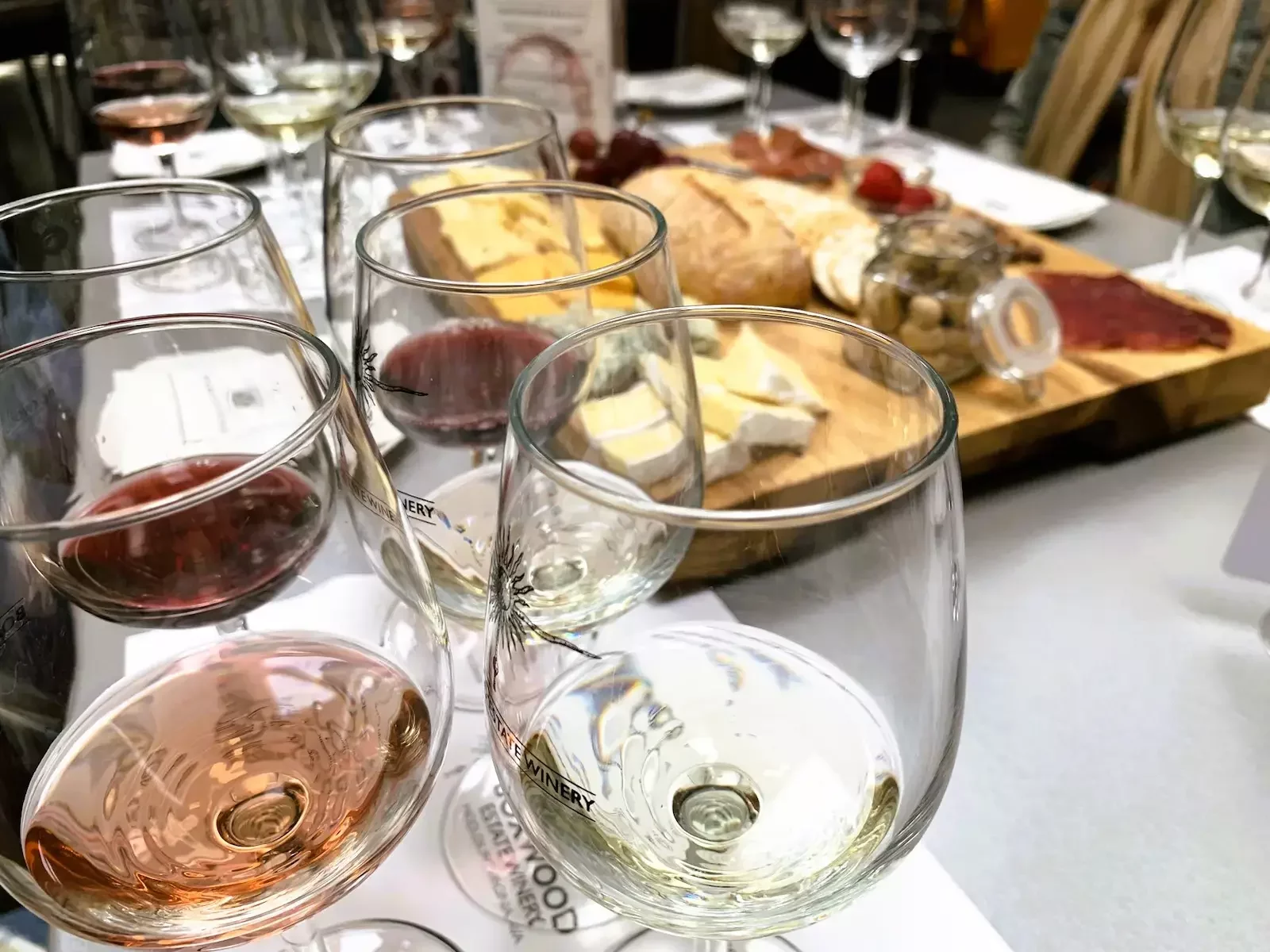 Guests enjoy wine and artisanal charcuterie at Boxwood Winery in Loudoun County, Virginia, inside the elegant barrel and tank room.